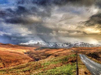 Scenic view of landscape against cloudy sky