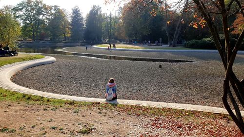 Girl sitting in park during autumn