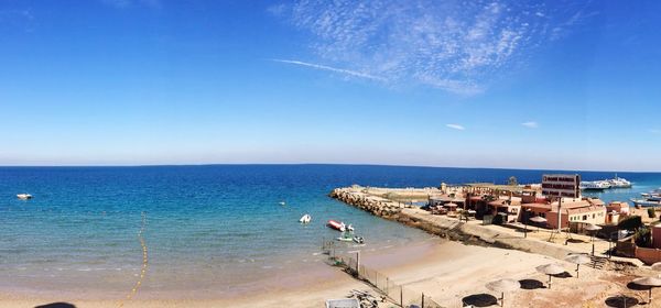 Scenic view of sea against blue sky