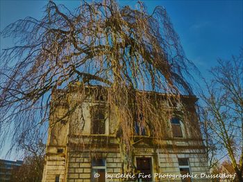 Low angle view of old building against clear blue sky