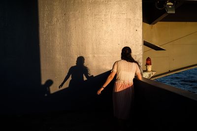 Rear view of people standing in water