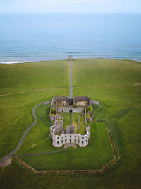 Aerial view of land and sea against sky