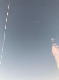 Low angle view of vapor trails in sky