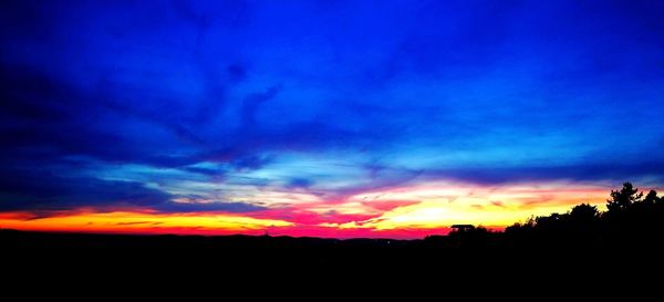 Silhouette landscape against dramatic sky