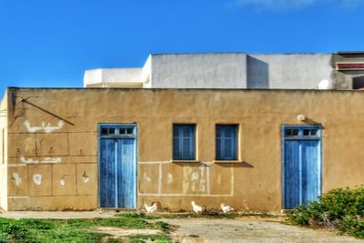 Exterior of old building against clear blue sky
