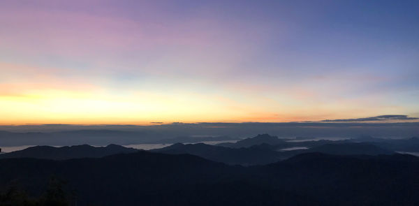 Scenic view of silhouette mountains against sky during sunset