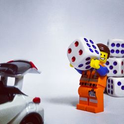 Close-up of toy car against colored background