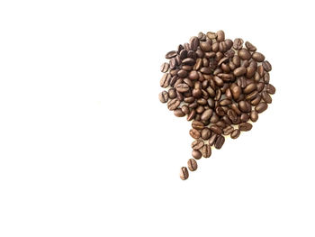 High angle view of coffee beans against white background