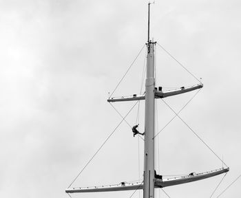 Low angle view of crane against sky