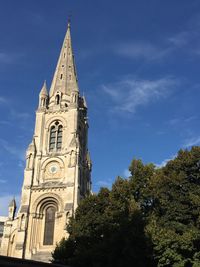 Low angle view of bell tower against sky