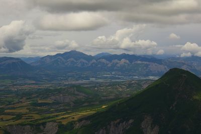 Scenic view of mountains against cloudy sky