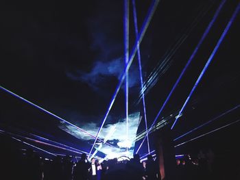 Low angle view of crowd at concert against sky at night