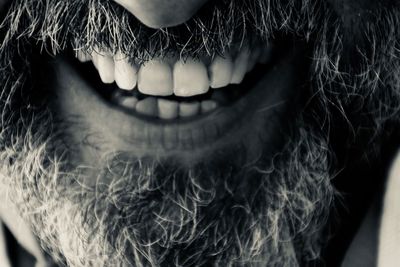Midsection of bearded man smiling