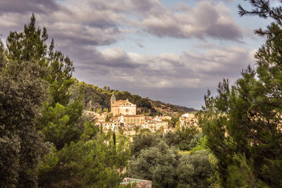 View of townscape against cloudy sky