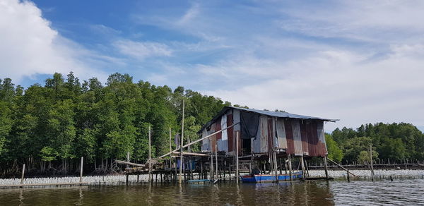 Building by river against sky