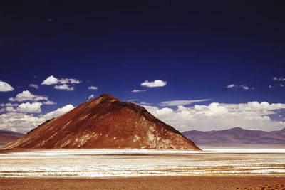 Scenic view of snowcapped mountains against blue sky