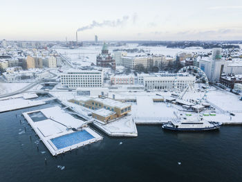 High angle view of buildings by sea against sky