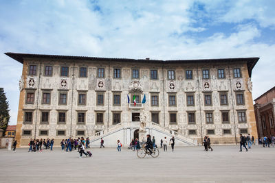 Tourists and locals at the palazzo della carovana built in 1564 located at knights square in pisa