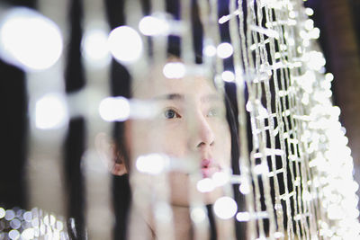 Close-up portrait of young woman looking away