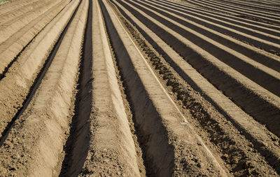 High angle view of tire tracks on railroad track