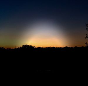Silhouette landscape against clear sky during sunset