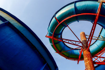 Low angle view of ferris wheel against blue sky