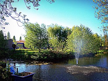 Swimming pool by lake against clear sky