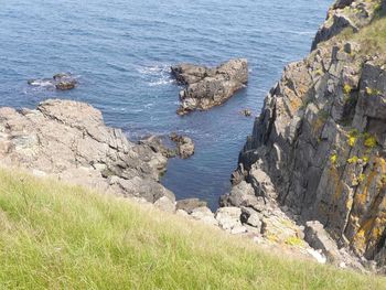 High angle view of rocks by sea