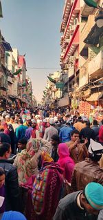 People on street market in city against sky