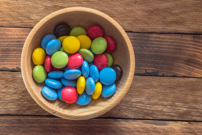 High angle view of multi colored candies in bowl on table