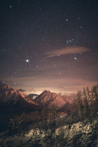 Scenic view of mountains against sky at night