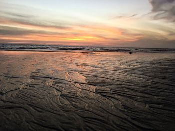 Scenic view of beach against sky during sunset