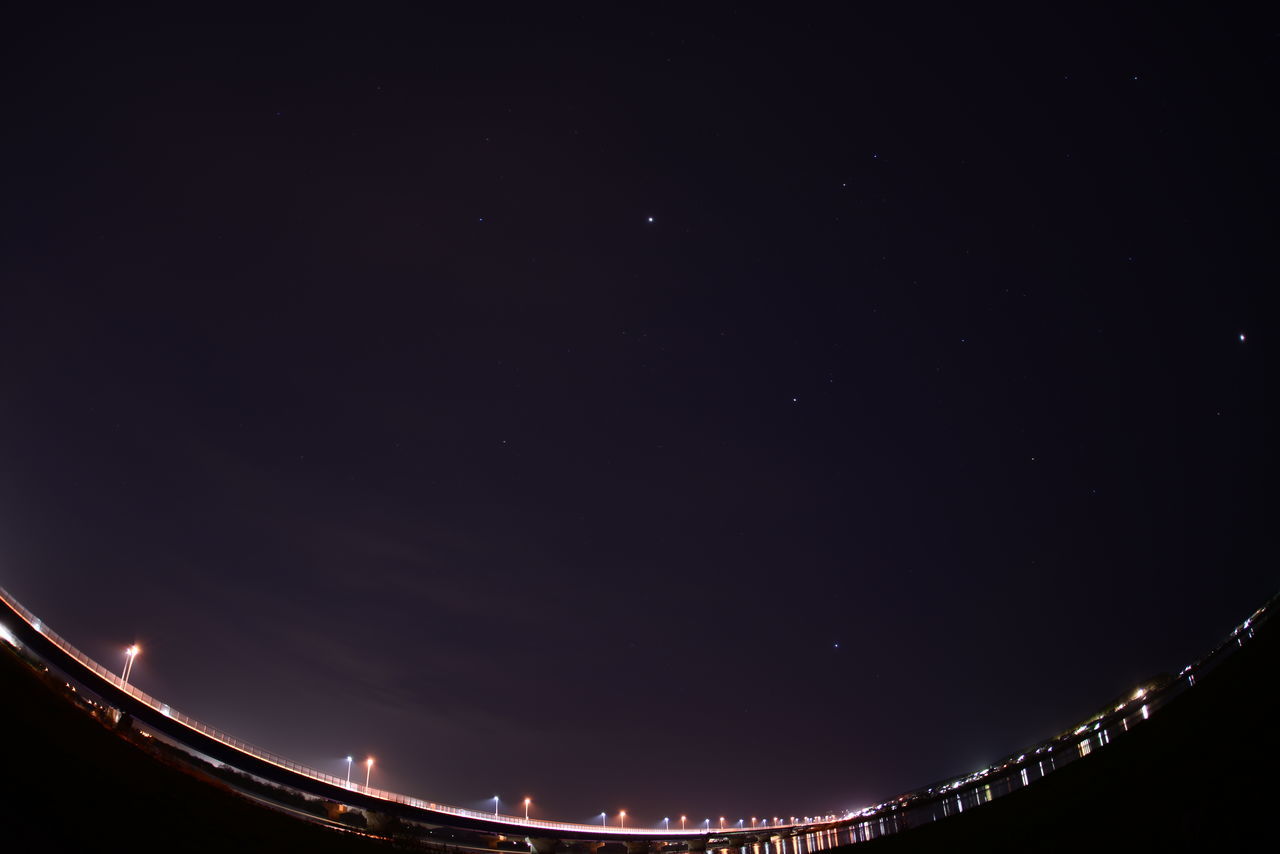 night, illuminated, copy space, clear sky, sky, built structure, moon, architecture, scenics, astronomy, low angle view, outdoors, dark, no people, nature, connection, beauty in nature, tranquil scene, city, tranquility