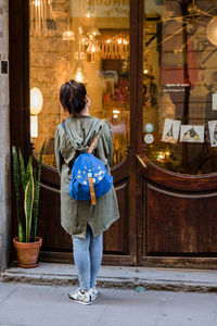 Rear view of woman standing at night