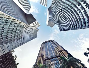 Low angle view of buildings against cloudy sky