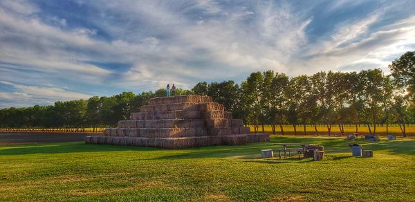 Built structure on field against sky