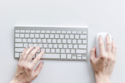 Midsection of person using mobile phone against white background