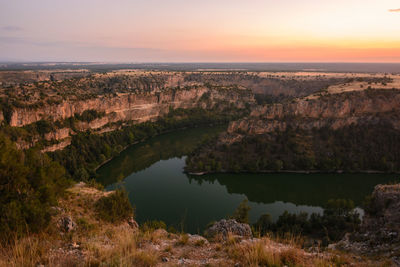 Scenic view of lake against sky during sunset