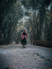 Full length of woman standing on snow covered land