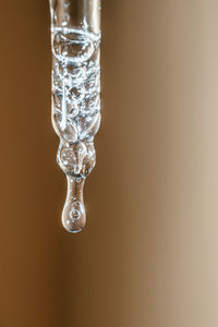 Close-up of frozen water against white background