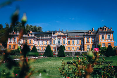 Building and trees against blue sky