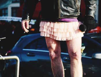 Low section of man wearing mini skirt while standing on road