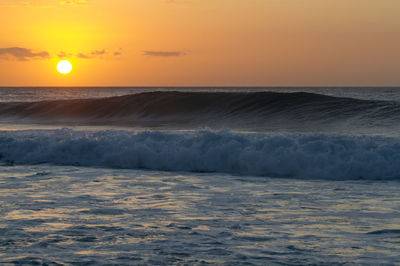 Scenic view of sea against orange sky