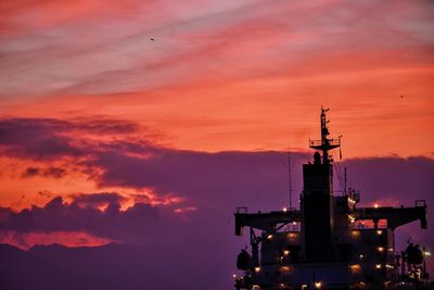 Low angle view of ship at harbor against sky during dusk