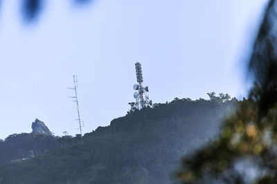 Low angle view of communications tower against sky