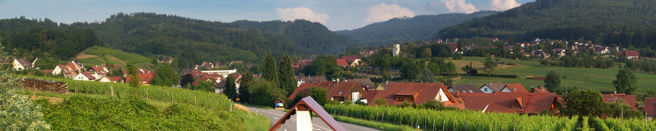 Panoramic view of people on mountain against sky