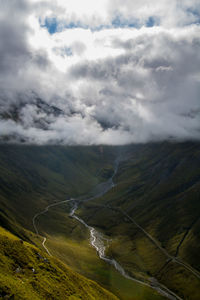 Scenic view of mountains against cloudy sky