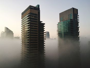 Low angle view of modern buildings in city against sky