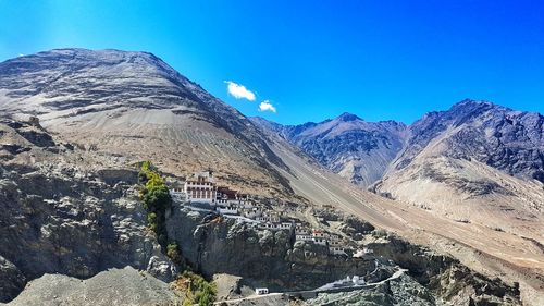 Scenic view of mountains against clear blue sky