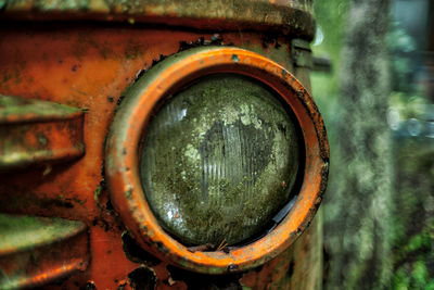 Close-up of abandoned rusty wheel